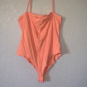 Orange spaghetti strap body suit. NEVER WORN